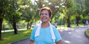 Smiling senior taking a walk outside to get rid of stress